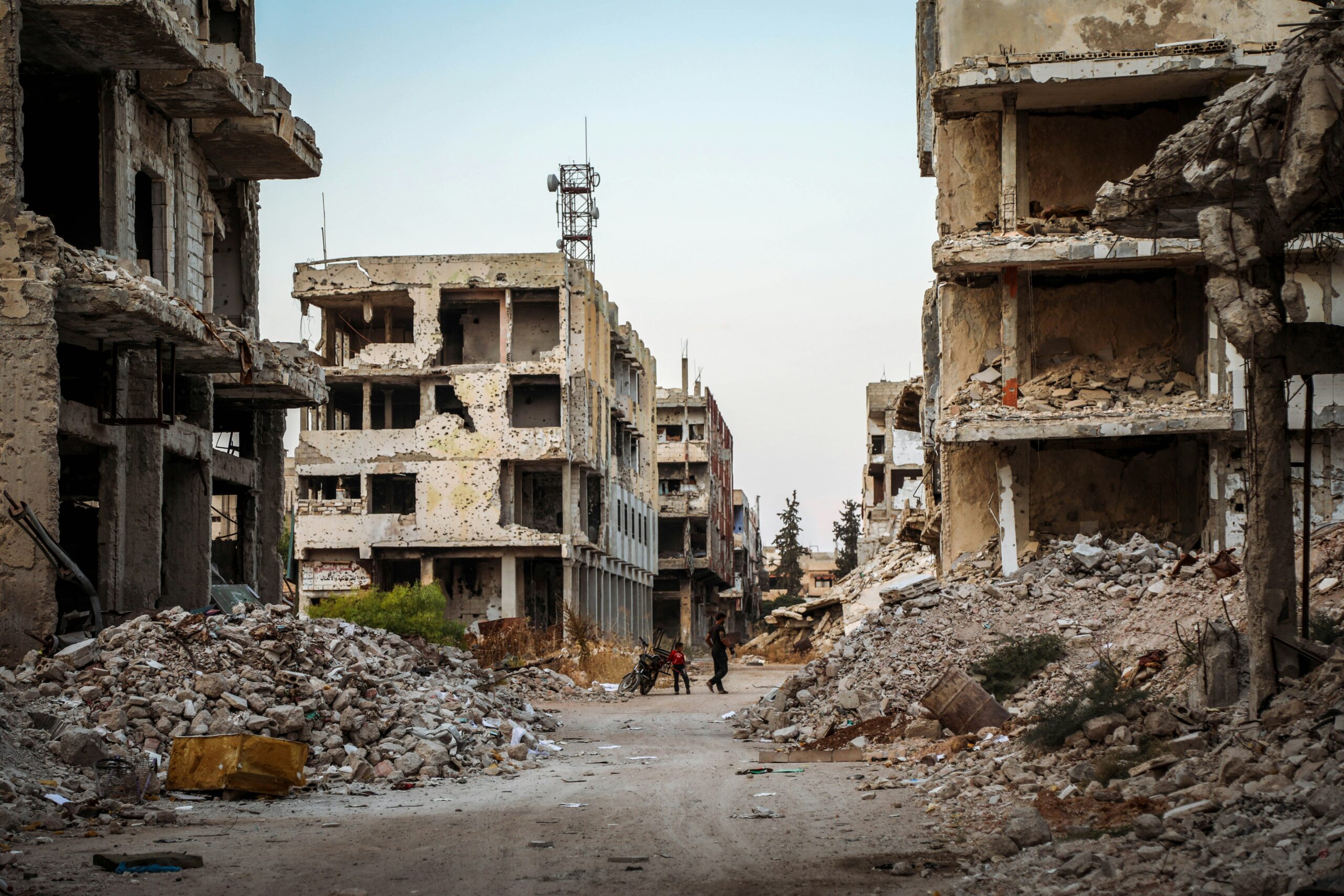War-damaged buildings in Syria illustrating the destruction of civilian infrastructure and the challenges facing international law during armed conflict.