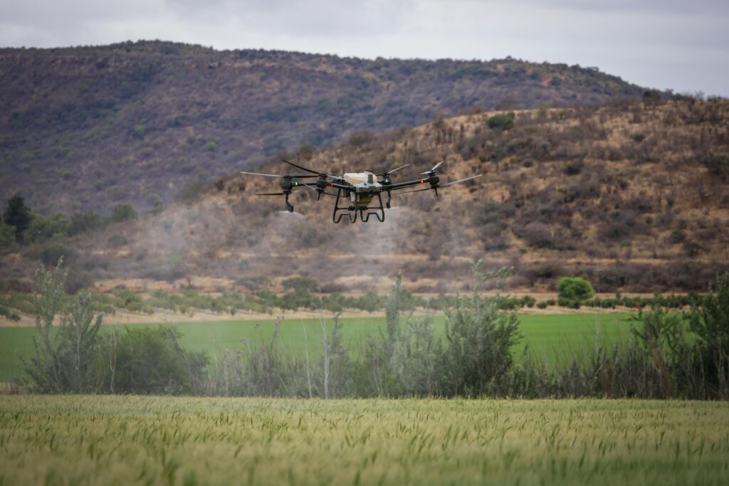 Agricultural drone flying over a crop field as part of a precision farming system