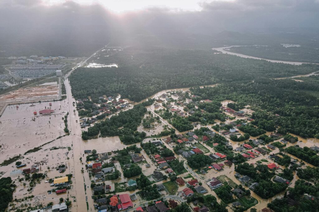 Aerial view of a flooded community showing the need for wide-area IoT networks and resilient communication systems for disaster recovery